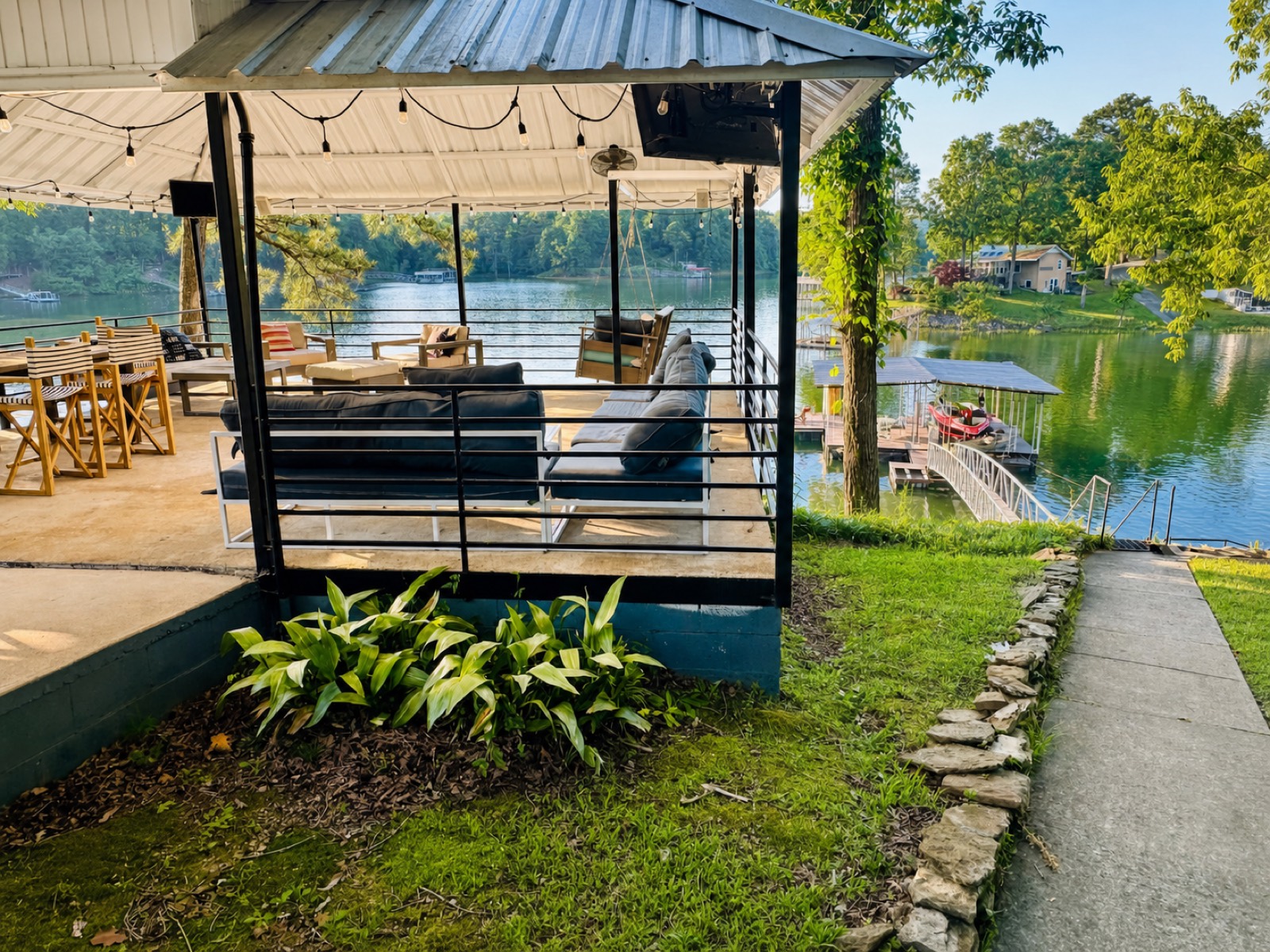 Covered lakeside terrace with outdoor seating